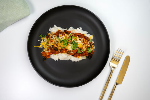 HealthyHolic Turkey Chili with Rice prepared meal with beans, cheddar cheese, and jasmine rice